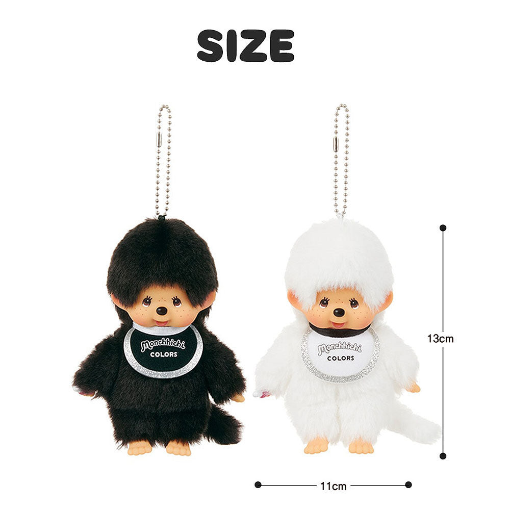 Two small plush toys, one black and one white, with 'Monchhichi' branding, on a white background with size measurements.