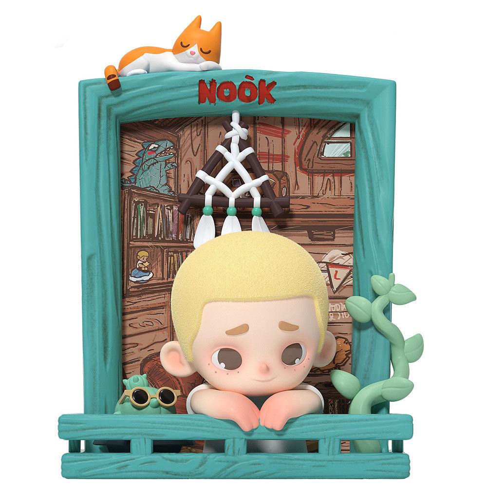 Toy figure with a teal frame and a character with blonde hair and sunglasses, set against a wooden interior background.