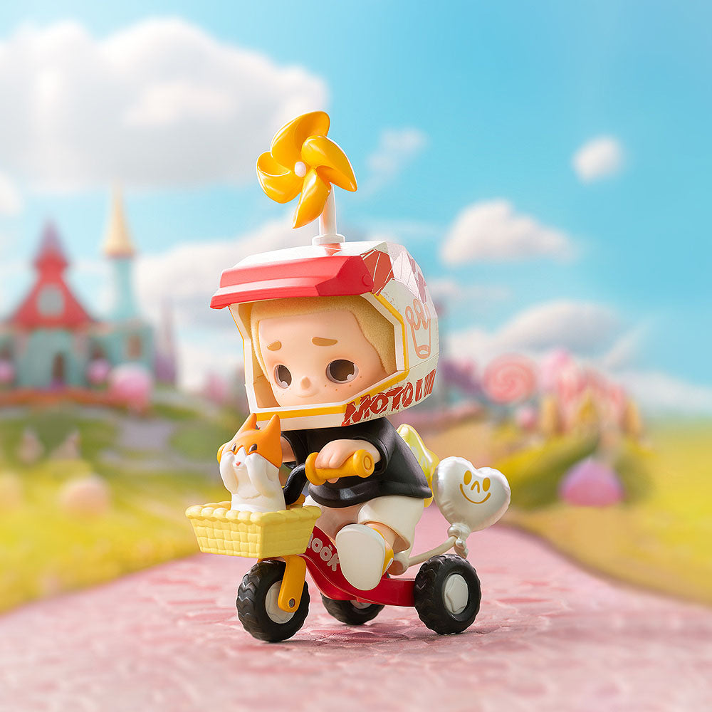 Toy figure of a character on a tricycle with a colorful background