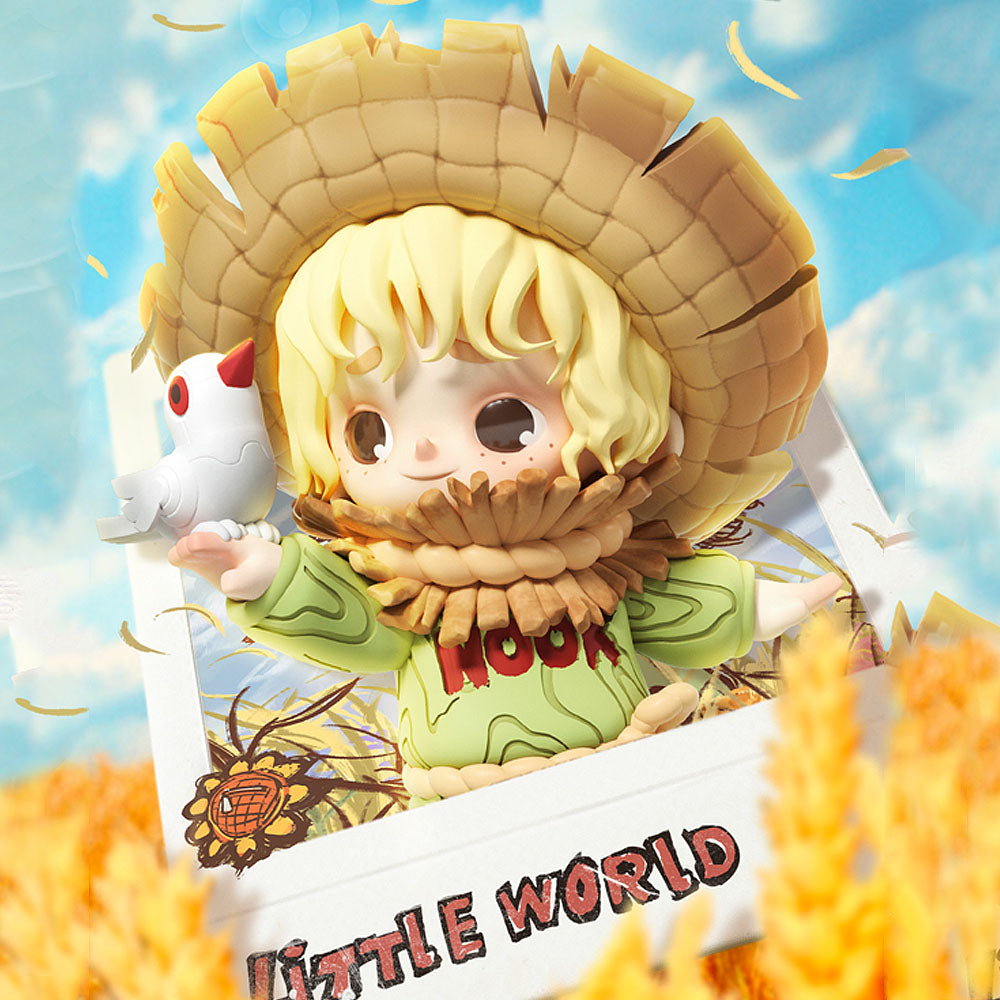 Toy figure of a character with a straw hat and a small bird, set against a bright blue sky.