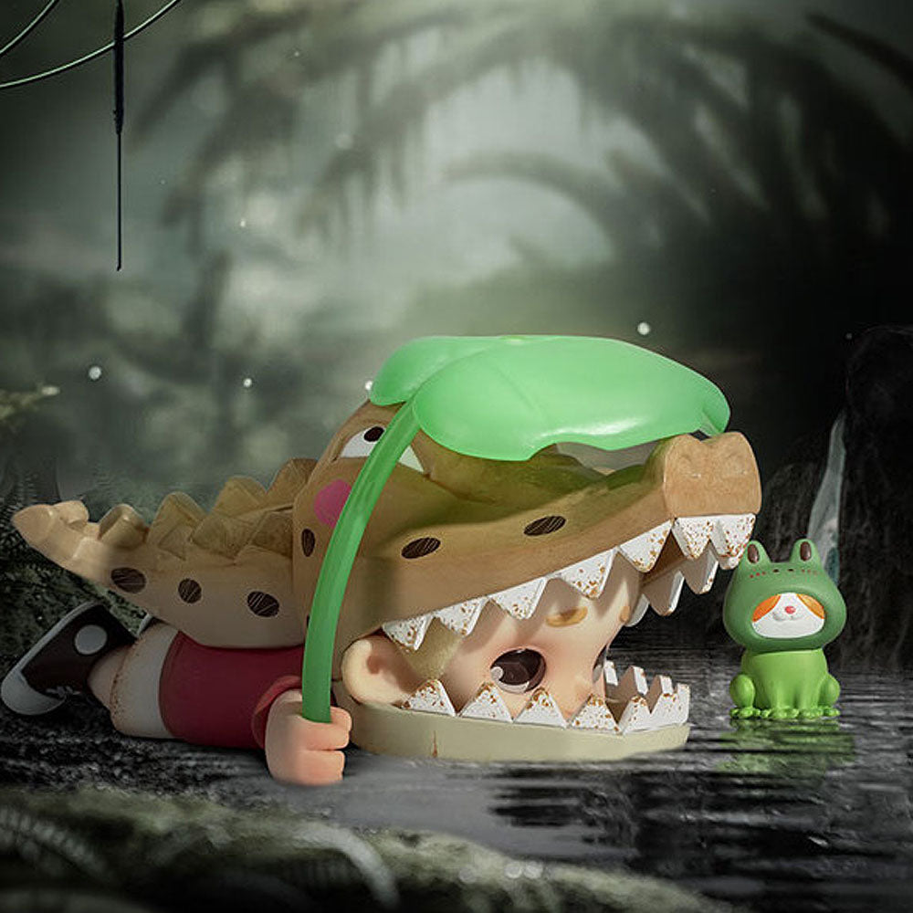 Toy alligator with a green leaf on its head in a dark forest setting