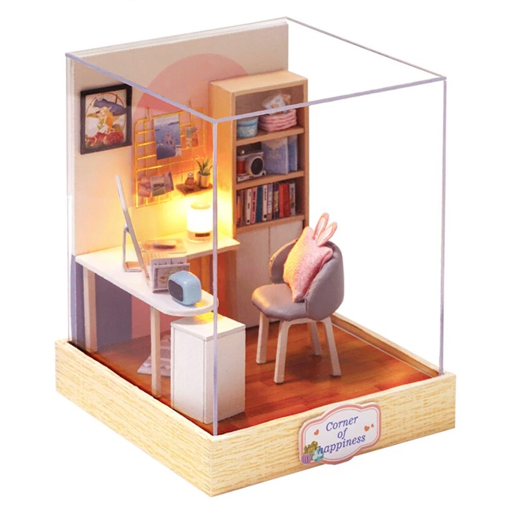 A cozy DIY miniature study room featuring a white desk with a computer, a bookshelf, and a gray chair with a pink bunny-ear cushion