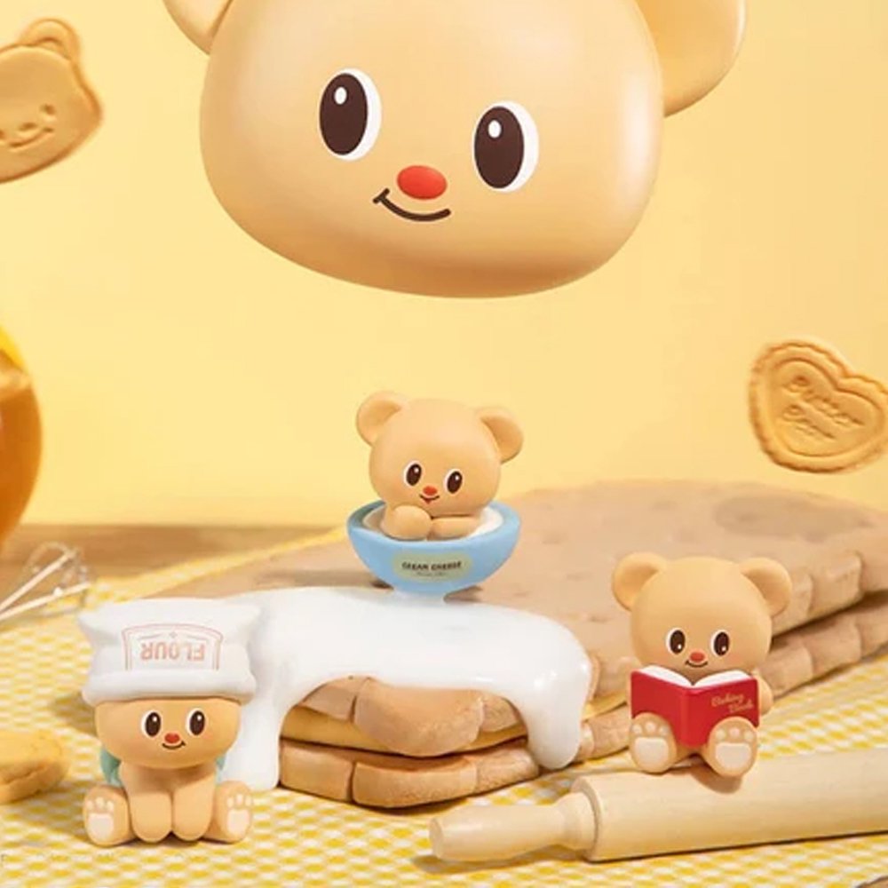 Officially licensed bakery-themed Butterbear collectible mini figures holding baking tools, wearing aprons, and posing with kitchen accessories