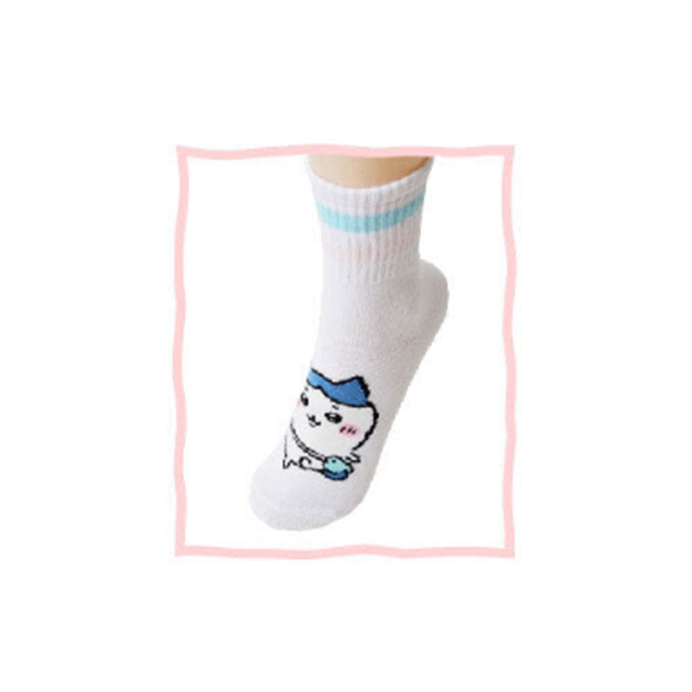 Featuring the pairs of officially licensed Chiikawa white crew-length socks, pink one holding a pink bear crossbody pouch and blue one holding a blue fish crossbody pouch.