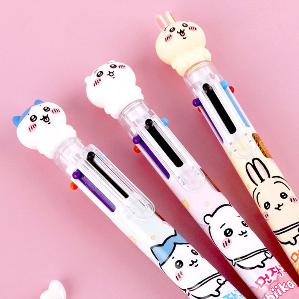 The officially licensed Chiikawa multi-color ballpoint pens in blue, pink, and yellow barrels. Each pen features a 3D character topper of Hachiware, Chiikawa, or Usagi and contains six different ink colors.