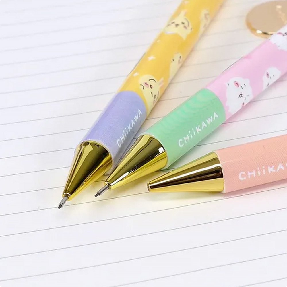 An official licensed collection of Chiikawa mechanical pencils in pink, blue, and yellow. Each pencil features a matching striped ball topper and a dangling enamel character charm of Chiikawa, Hachiware, or Usagi.