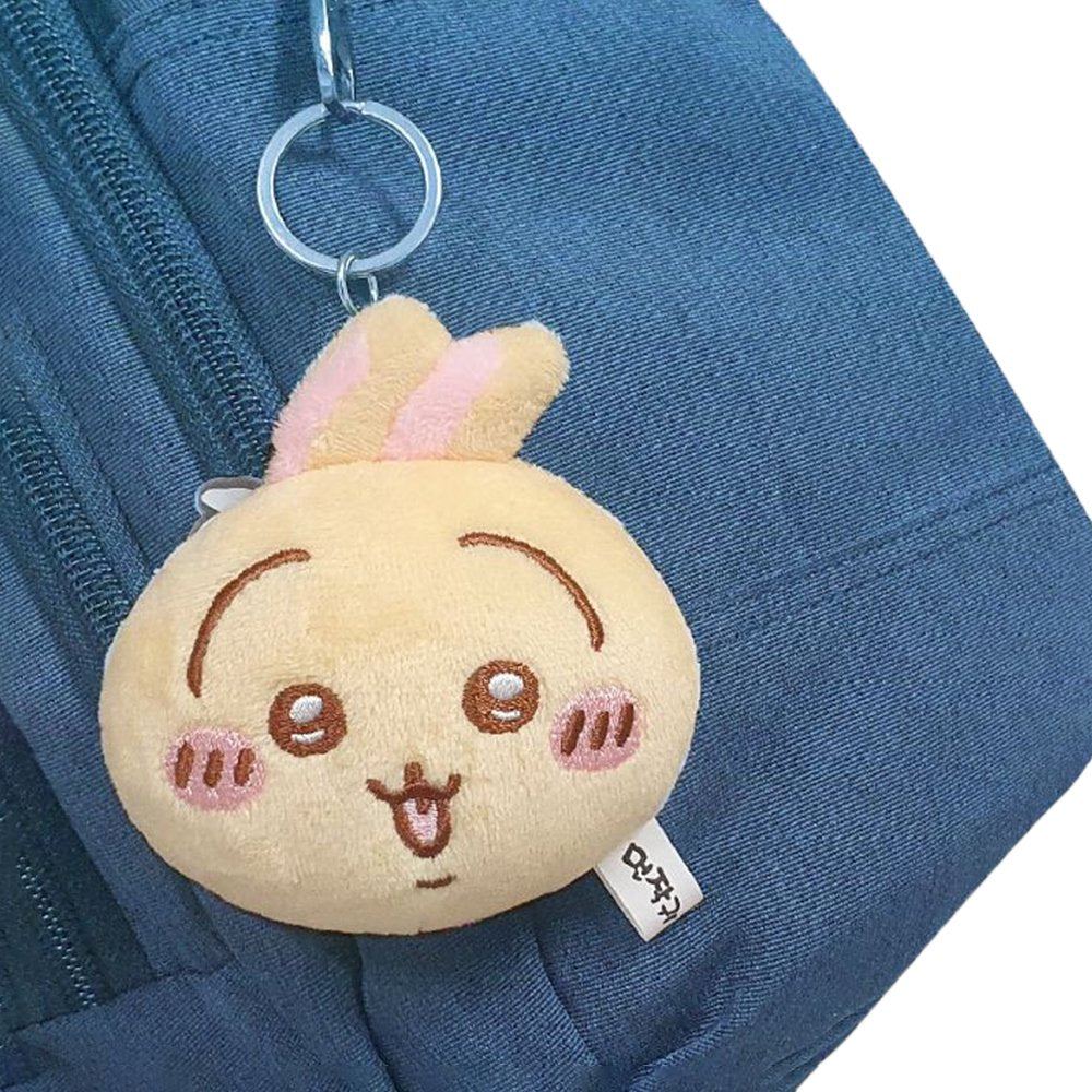 The officially licensed Usagi plush mirror keychains featuring two circular plush heads, one yellow and one red, show Usagi's embroidered face and long ears. The reverse side of the plush, revealing a built-in circular vanity mirror with a metal ring and a small character-themed acrylic charm.