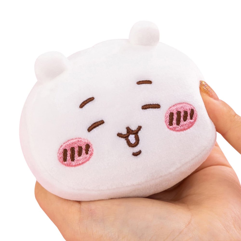 A group of five officially licensed Chiikawa plush face charms, including characters like Chiikawa, Hachiware, and Usagi, shown with colorful ears and pink blushing cheeks. Each round, soft mascot features a pink hanging loop.