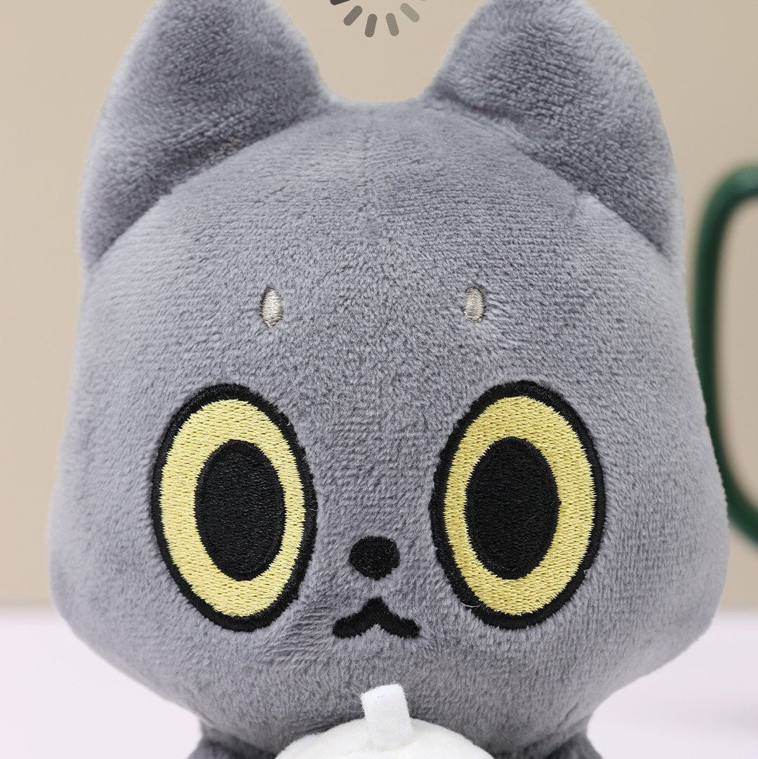 Black Cat plush toy with large black and yellow eyes on a beige background