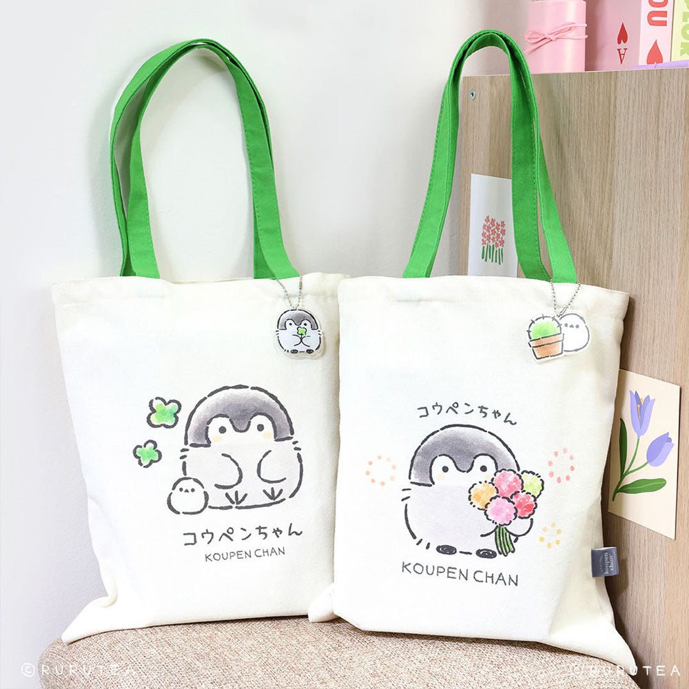 Koupen Chan Tote Bags : Official licensed Koupen Chan canvas tote bags with green handles. One features the penguin with clovers, the other with a flower bouquet.