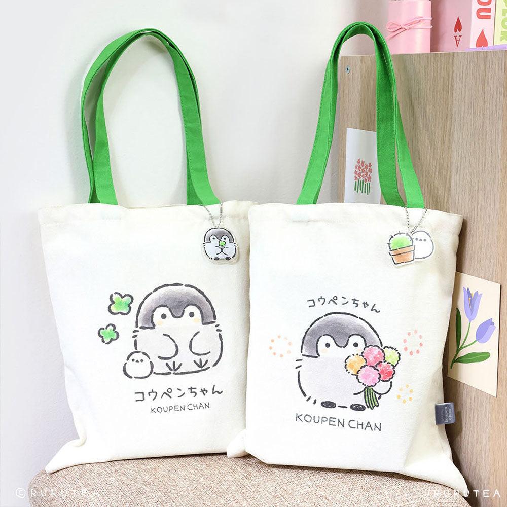 Koupen Chan Tote Bags : Official licensed Koupen Chan canvas tote bags with green handles. One features the penguin with clovers, the other with a flower bouquet.