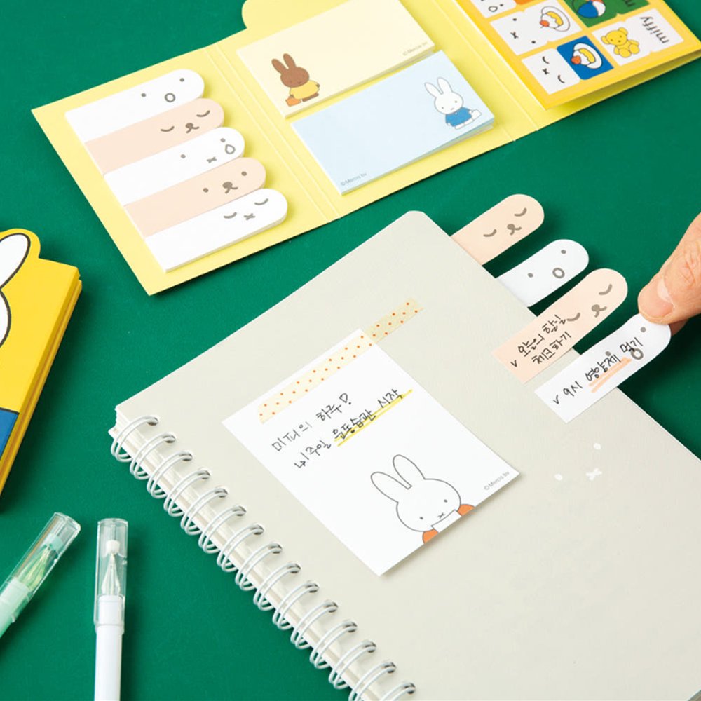 Officially licensed Miffy sticky note booklets featuring different covers—one showing Miffy holding a tray of orange flowers on a white background, and the other showing Miffy eating with a blue spoon on a yellow background