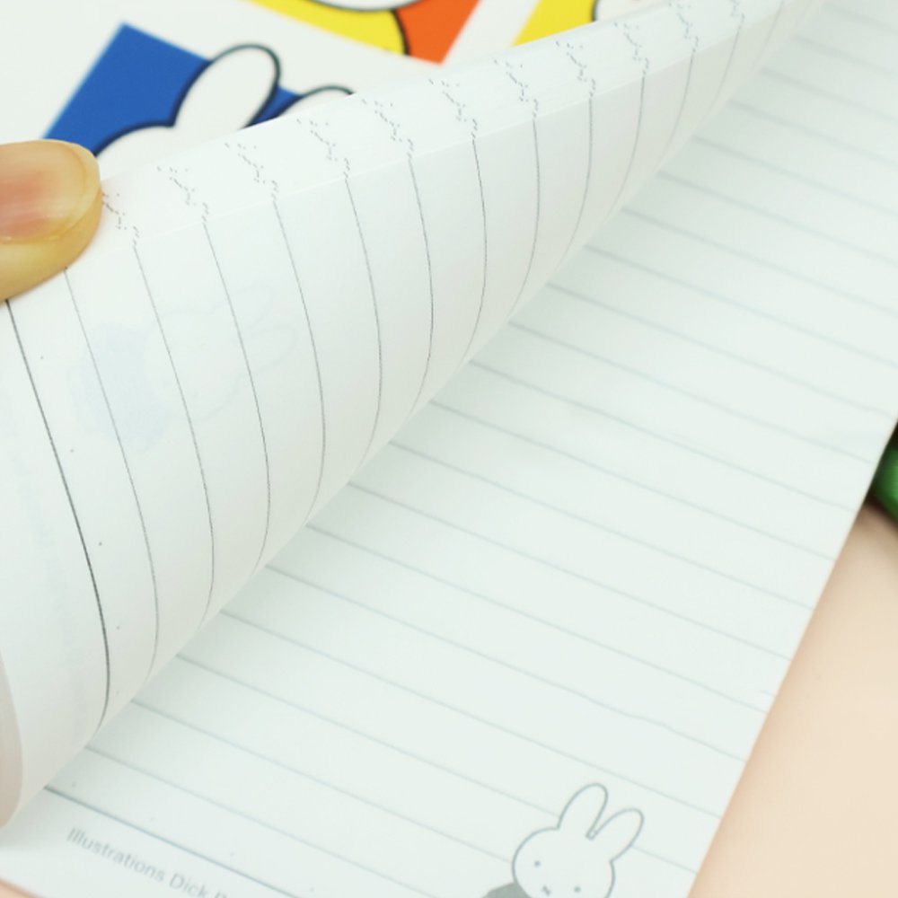 An officially licensed collection of colorful Miffy lined notebooks featuring illustrated covers and a close-up of lined inner pages with a small Miffy illustration printed at the bottom corner.
