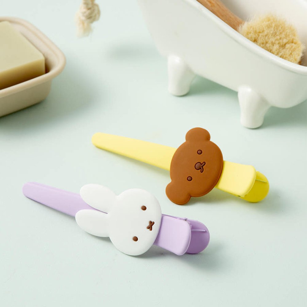 Officially licensed Miffy salon-style big hair clips, featuring one in pastel purple with a white Miffy bunny charm, and the other one in pastel yellow with a brown Boris Bear charm.