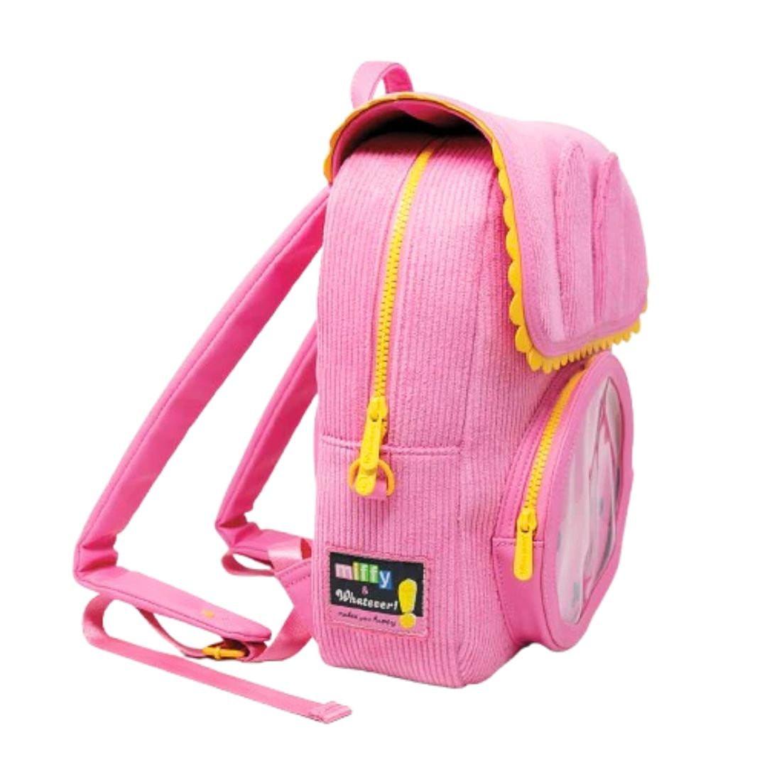 Officially licensed pink corduroy Miffy backpack. The front panel has a circular window pocket with Miffy's face, and the top flap is shaped like rabbit ears with a scalloped yellow trim.
