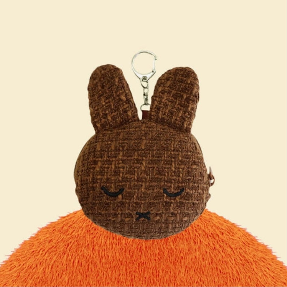 An officially licensed Miffy Melanie brown tweed pouch featuring sleeping embroidered eyes and an attached silver clip.