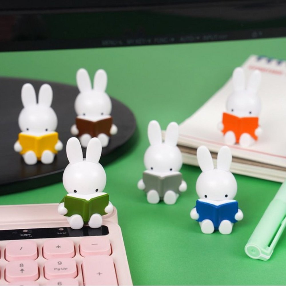 Officially licensed Miffy Reading a Book Mini Figure Blind Box featuring Miffy sculpted sitting down and holding an open book in various colors