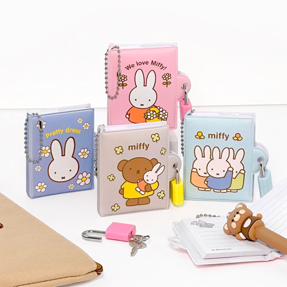 An officially licensed collection of Miffy secret mini notebooks in soft pink, light blue, blue, and grey. Each notebook features a padded cover with Miffy or Boris Bear illustrations, a silver ball chain, and a color-coordinated miniature padlock with keys.