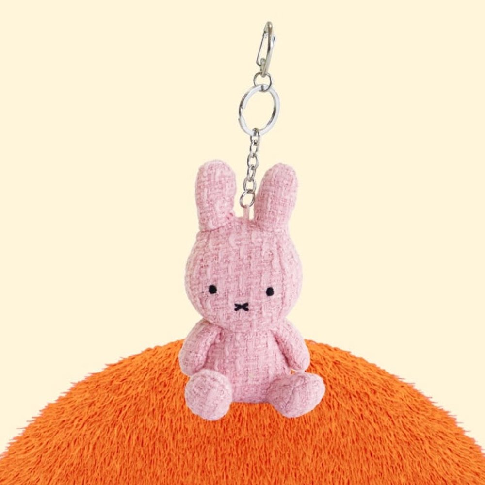 Four officially licensed Miffy textured tweed plush keychains lined up in pink, sage green, cream, and navy blue with attached silver keyrings