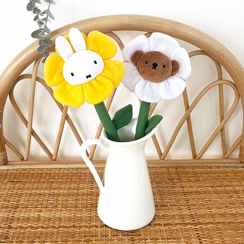 A collection of Miffy Friends Flower Plushies stuffed animals in various colors, each designed to look like a flower with animal faces in the center.