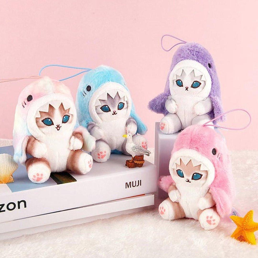 Officially Licensed Mofusand Pastel Shark Meow Plush Keychain! These authentic cats in pastel marble, pastel blue, pastel pink, and pastel purple shark hoodies feature stunning blue eyes, pink paw pads, and a playful open-mouth expression. Perfect for ornament , displaying, bag charm or gifting to Mofusand fans of all ages.