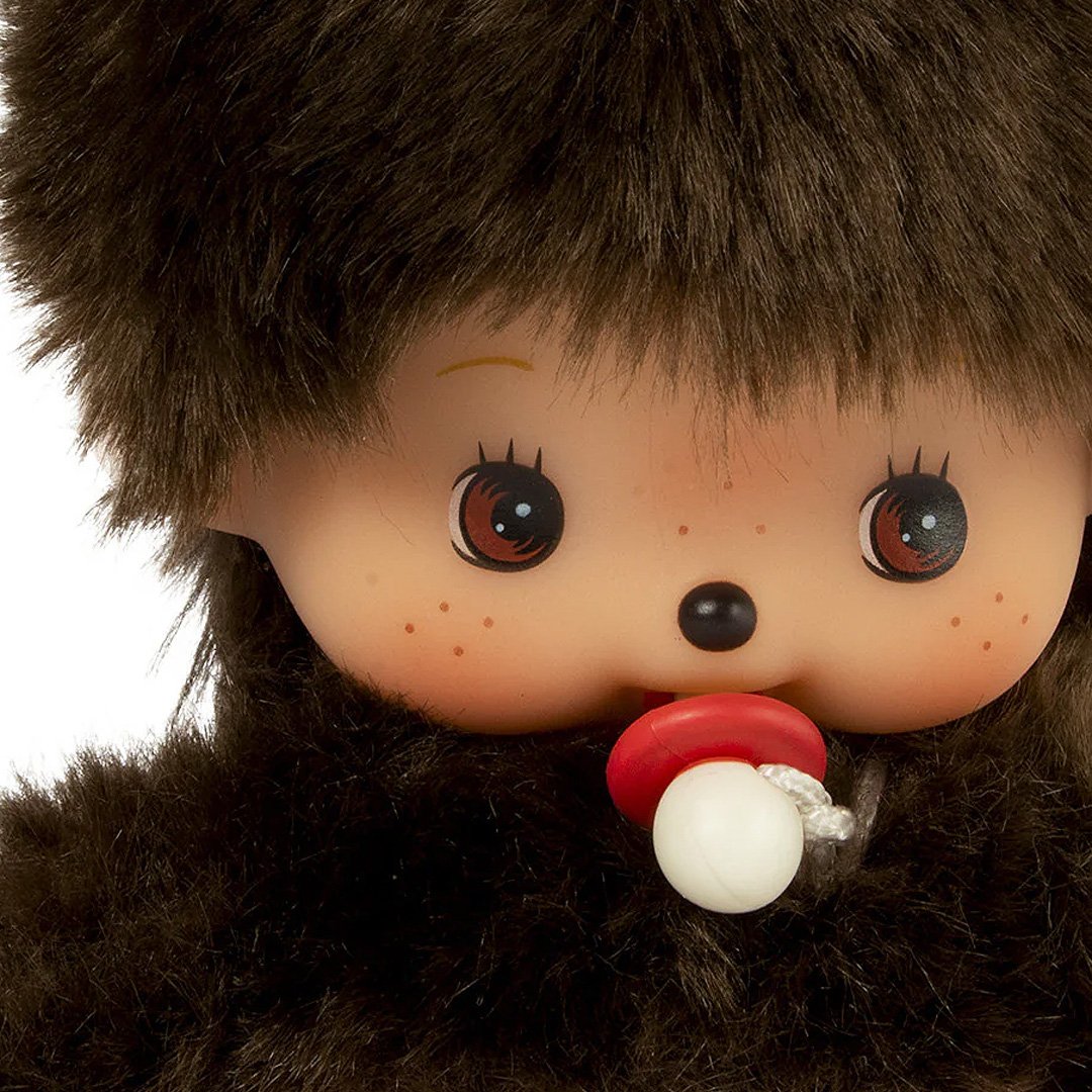 Official license Mochhichi dressed in baby suits with bows, these baby Monchhichis come with a tiny pacifier for an extra sweet touch. Their soft plush material and charming baby-style outfits make them the perfect collectible or gift for Monchhichi fans.