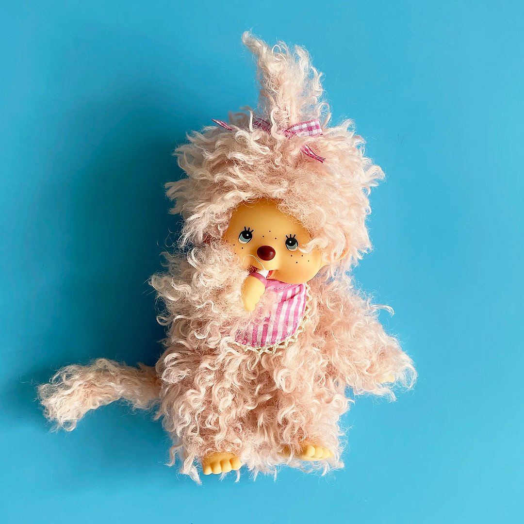 Officially licensed by Sekiguchi Japan, Monchhichi girl dressed in luxurious pink-beige plush fur with her signature thumb-sucking pose. She’s perfect for cuddling, displaying, or gifting to Monchhichi fans of all ages.