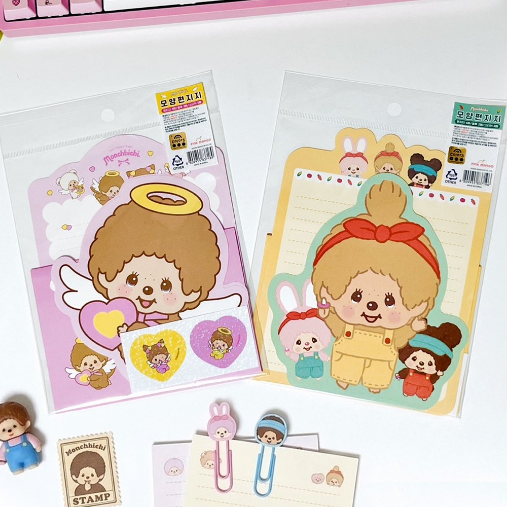 An officially licensed Monchhichi letter writing set displayed with die-cut stationary paper in pink and yellow themes, matching envelopes, and heart sealing stickers