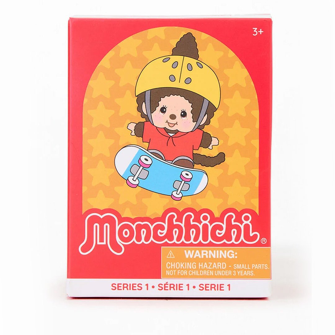 Monchhichi toy packaging with a monkey character on a skateboard against a red and yellow background.