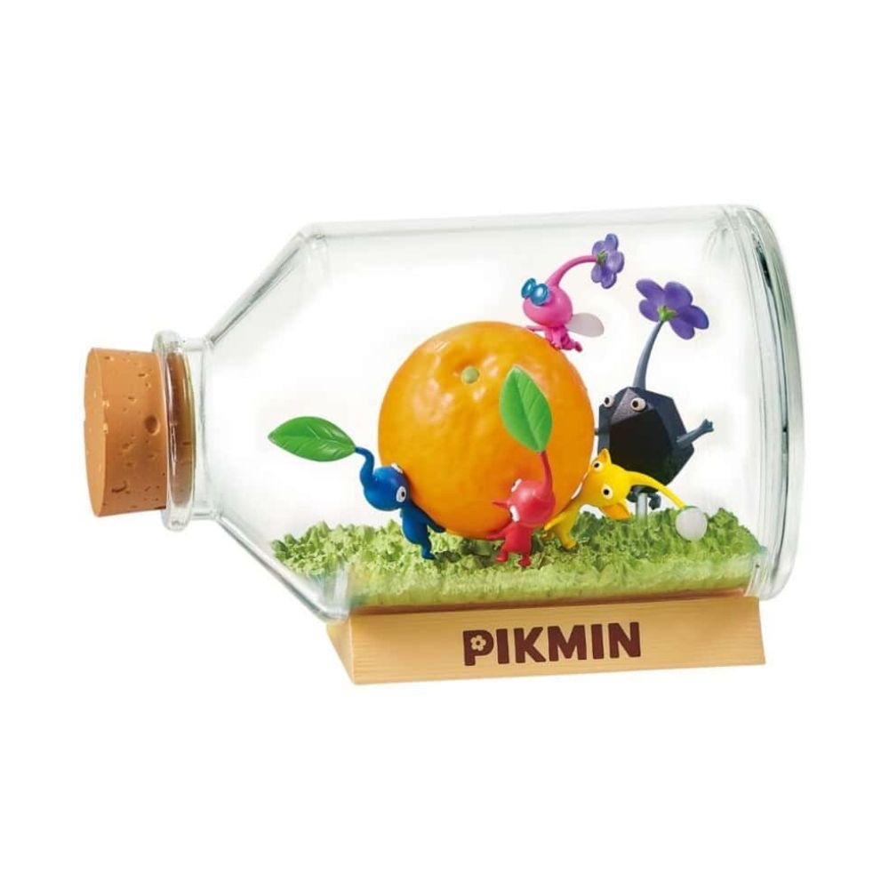 Officially licensed Re-Ment Pikmin Terrarium Collection Figure featuring one Red, one Blue, and one Yellow Pikmin. The Blue and Red Pikmin carry large orange inside a horizontal clear bottle with a cork stopper, resting on a rocky diorama base near a miniature fire element.