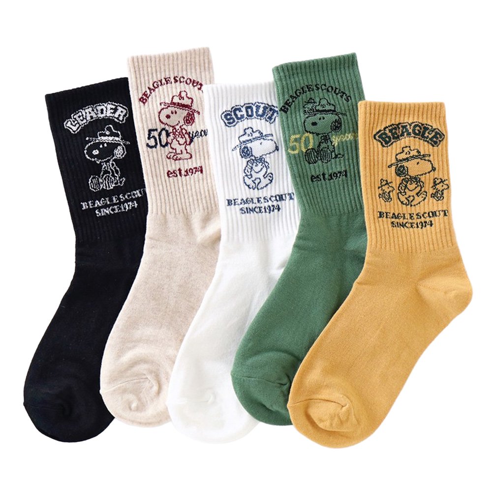 A set of five crew-length socks in black, beige, white, green, and mustard yellow. Each sock features an embroidered graphic of Snoopy as a Beagle Scout leader.