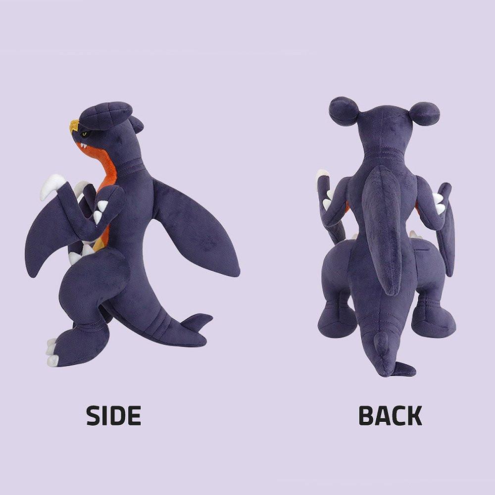 Pokemon Garchomp Plush toy of a character with orange, purple, and yellow colors on a Purple Background