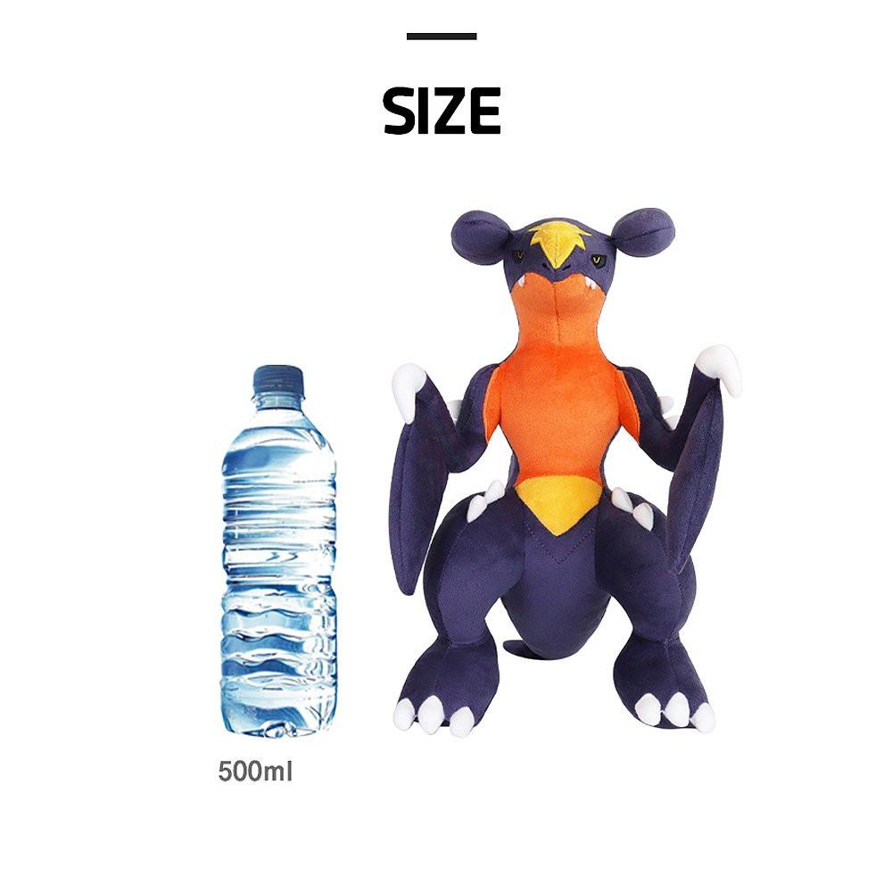 Pokemon Garchomp Plush toy next to a water bottle with 'SIZE' text above