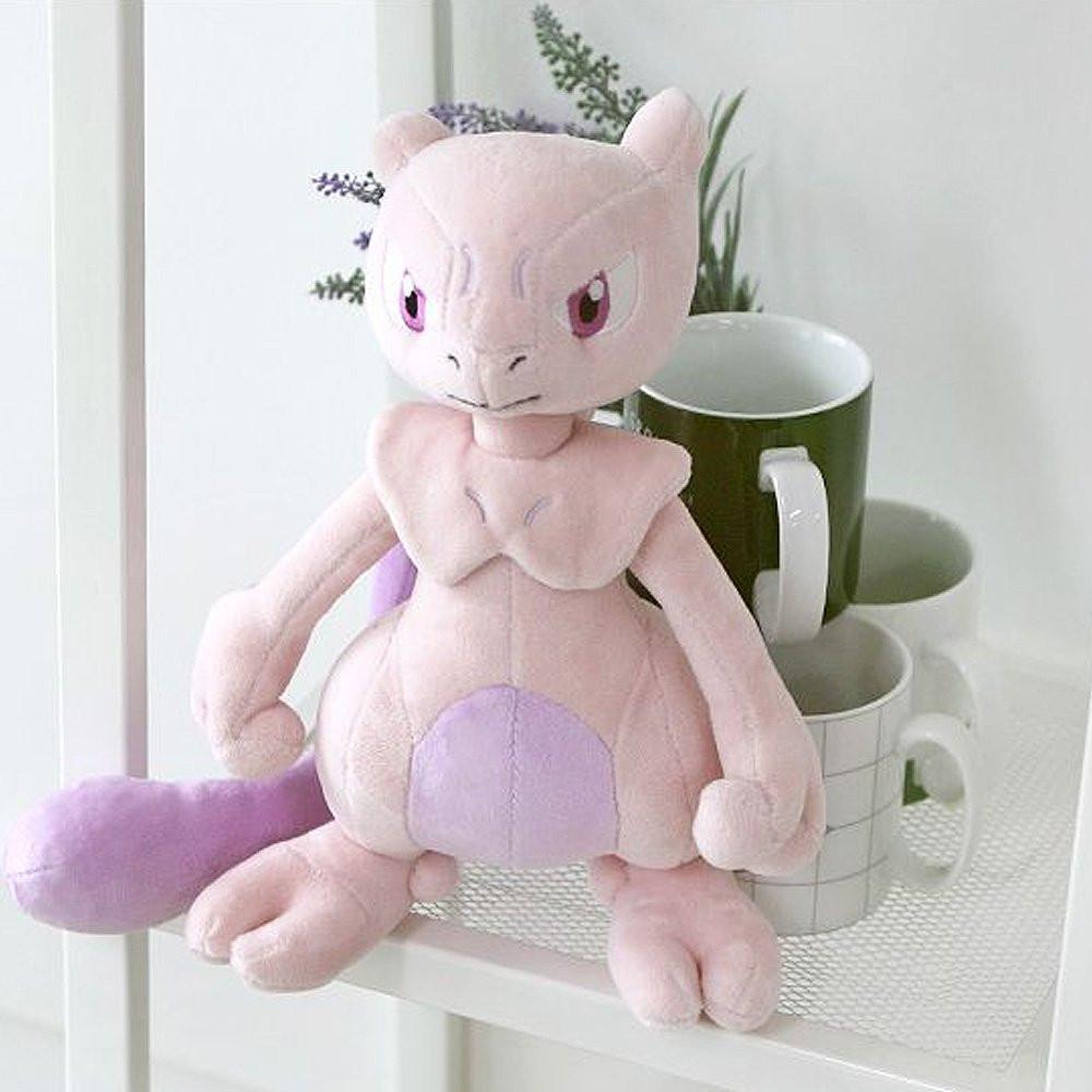 A soft plush toy of the Pokémon Mewtwo, featuring its light purple body, darker purple belly, and long tail, standing upright on a white background