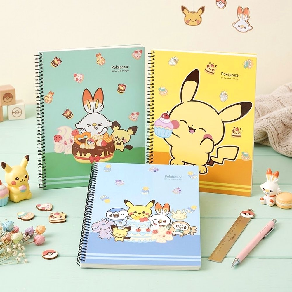 Three pastel-colored Pokemon Pokepeace spiral notebooks showcase adorable illustrations of Pikachu, Scorbunny, and other characters alongside cakes and sweets on green, yellow, and blue covers.