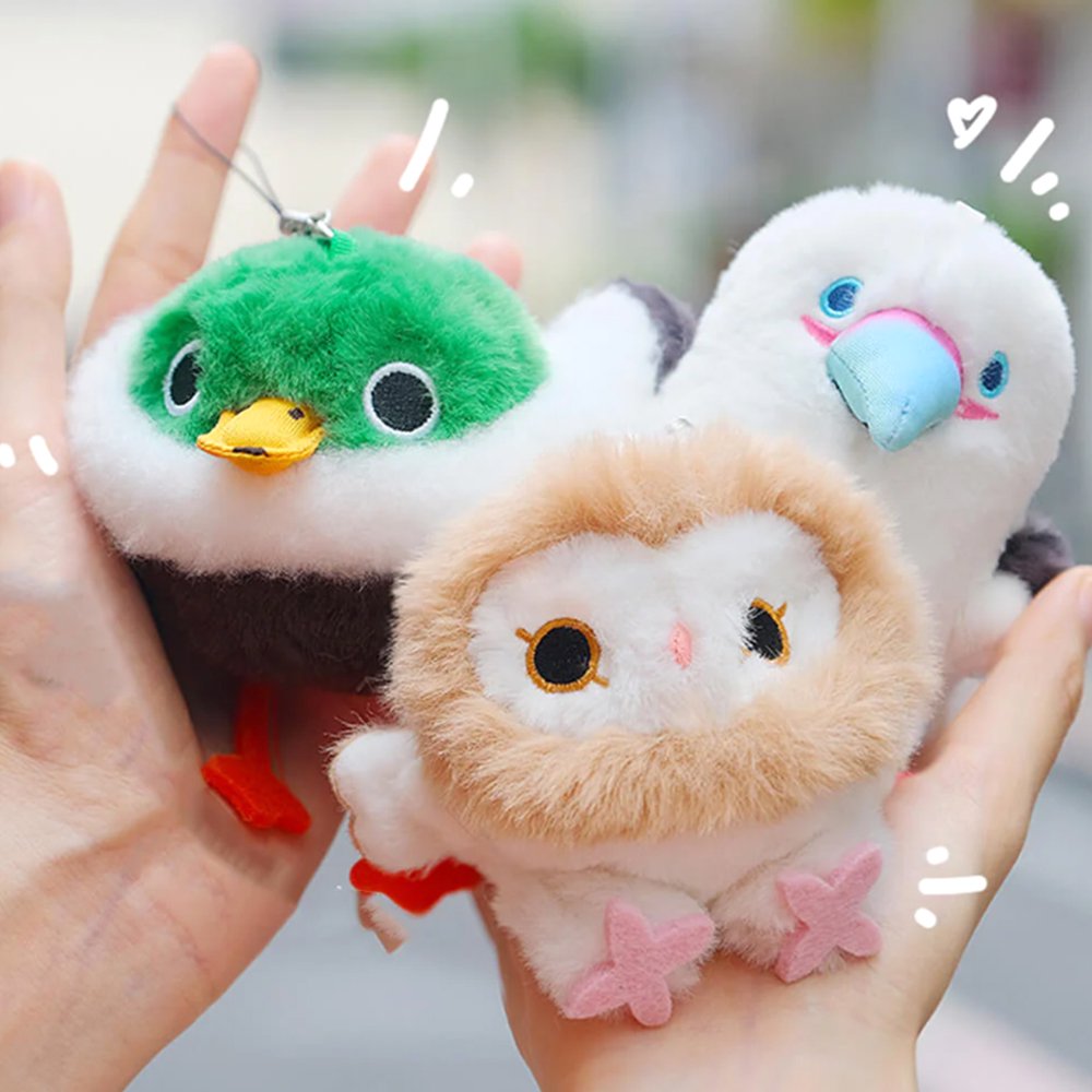 A round, fluffy Barn Owl bird plush keychain with a white face, tan ruff, and pink star-shaped feet
