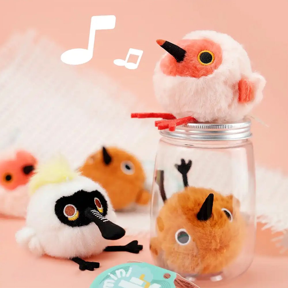A round, fluffy Black-faced Spoonbill bird plush keychain with a distinctive long beak, a playful tuft of yellow fur, and small black feet