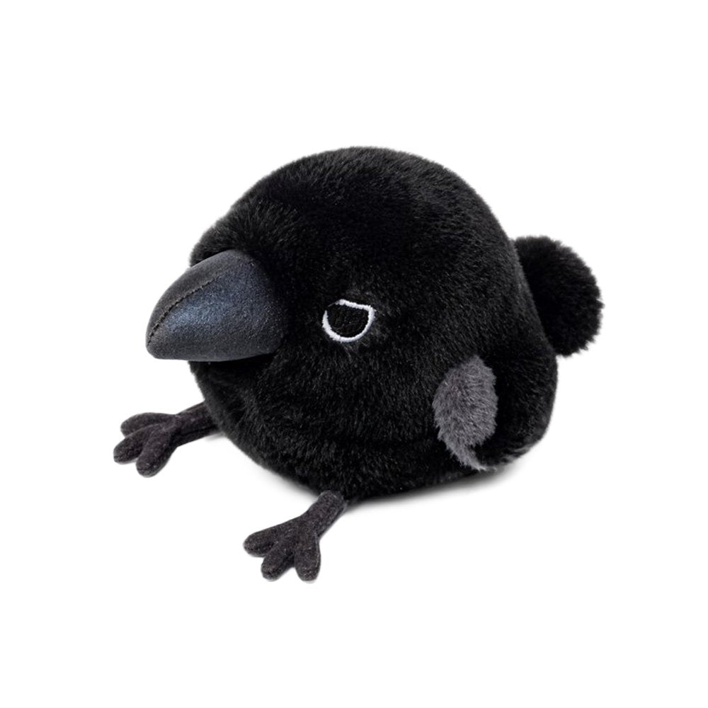 A round, fluffy black crow plush keychain features a large shiny dark blue beak, small embroidered eyes, tiny grey wing patches, and small black feet sticking out from its spherical body.