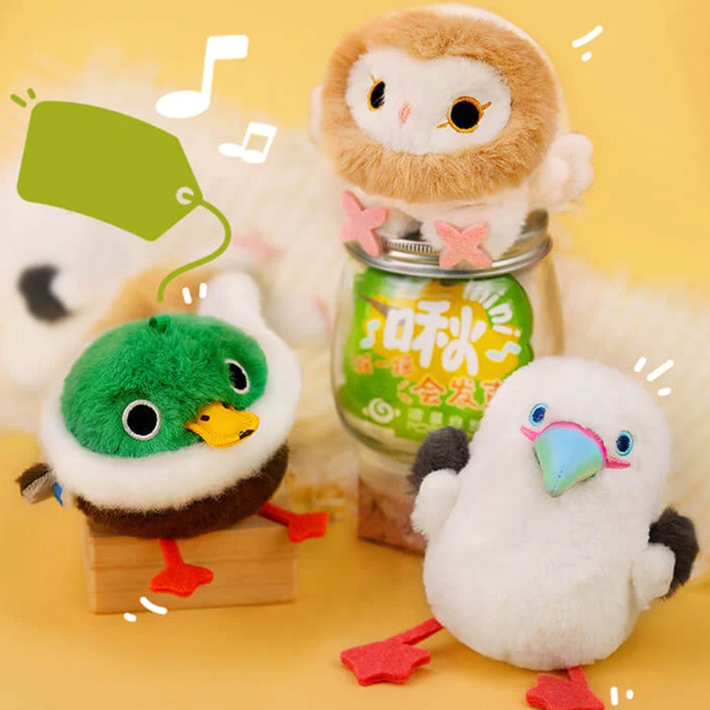 A round, fluffy white Red-footed Booby bird plush keychain featuring grey wings, a blue beak, and bright pink webbed feet