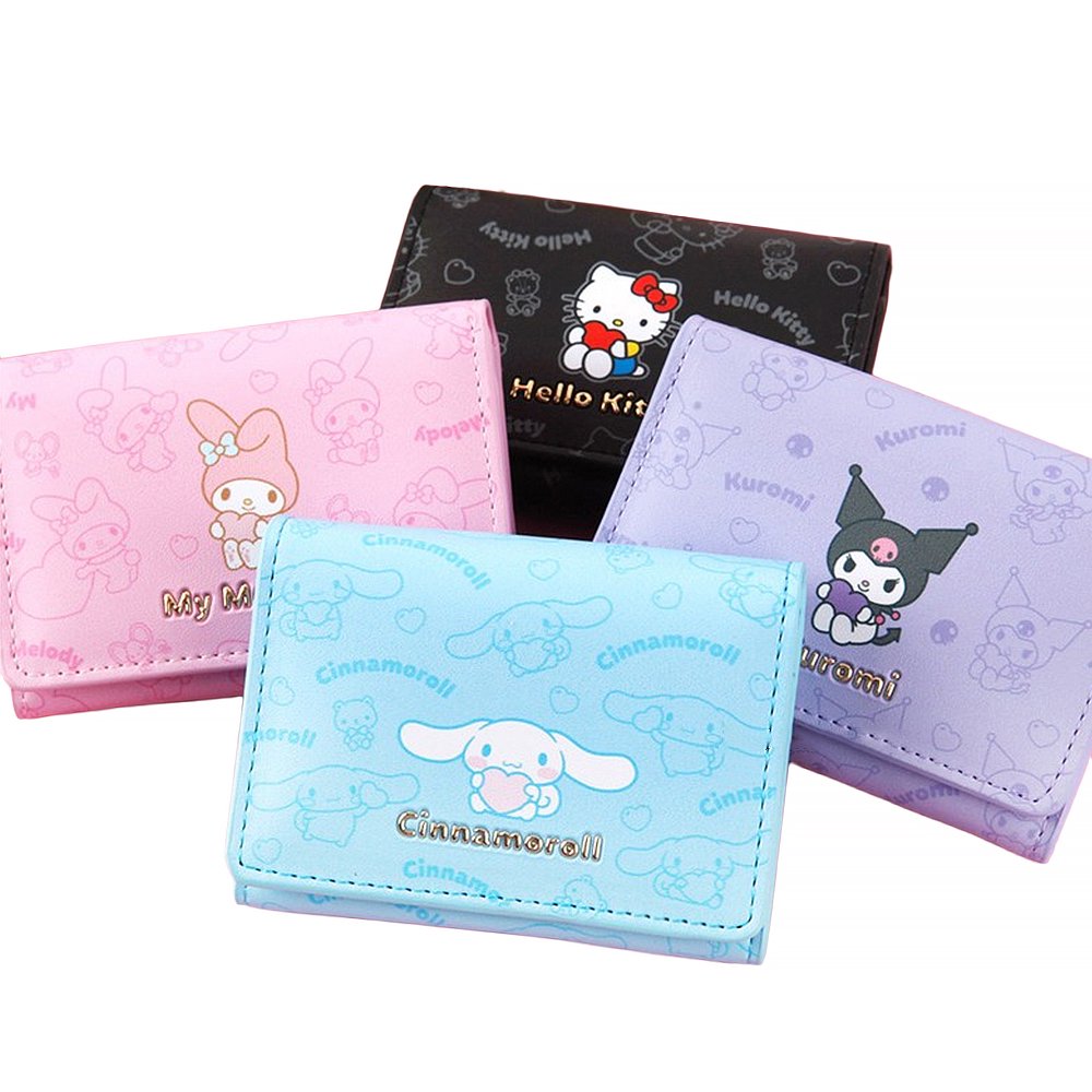 An officially licensed collection of four Sanrio character mini wallets in black, pink, purple, and blue featuring Hello Kitty, My Melody, Cinnamoroll, and Kuromi with gold-lettered names.