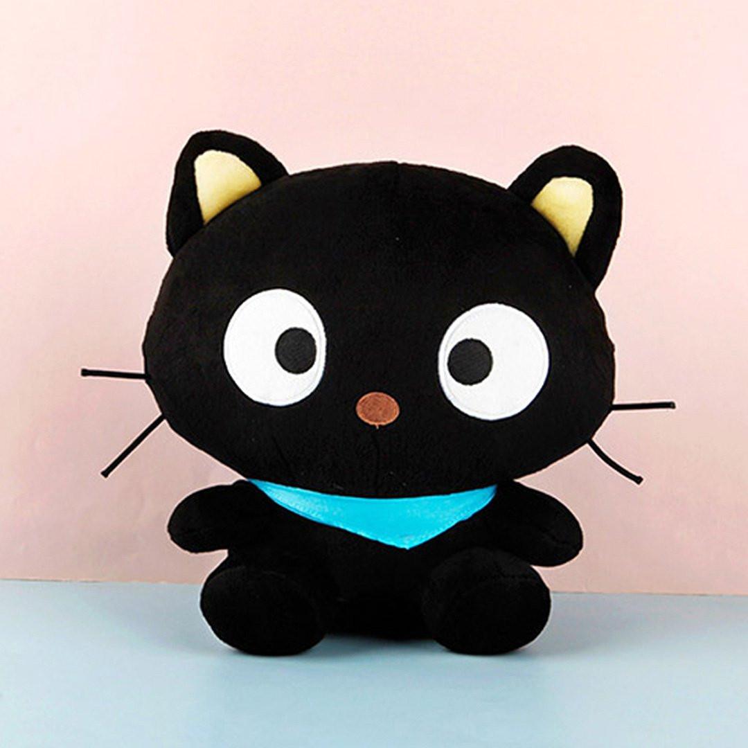 An officially licensed Sanrio Chococat 10-inch plush toy featuring a black kitten with large, iconic circular white eyes, thin black whiskers, and cream-colored inner ears. The plush is wearing a vibrant light blue triangular scarf around its neck and is shown in a sitting pose against a soft pastel background.