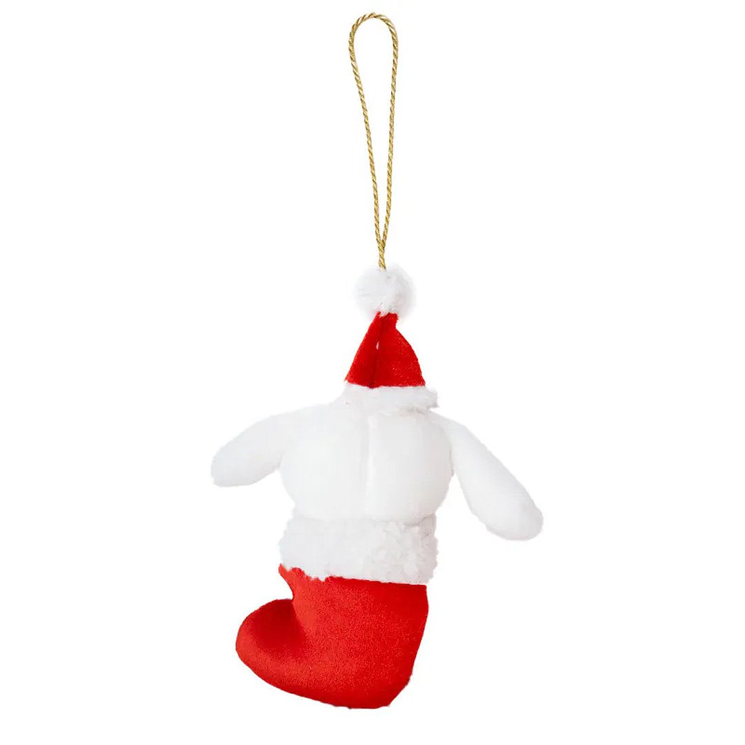 Sanrio Cinnamoroll is dressed for the season wearing a red Santa hat with a white pom-pom while sporting his signature red bow. He sits snugly in a red Christmas stocking adorned with green holly leaves and a decorative ribbon. Crafted from soft plush material, this ornament has a cozy, huggable feel. The attached gold cord loop makes it easy to hang on your Christmas tree.