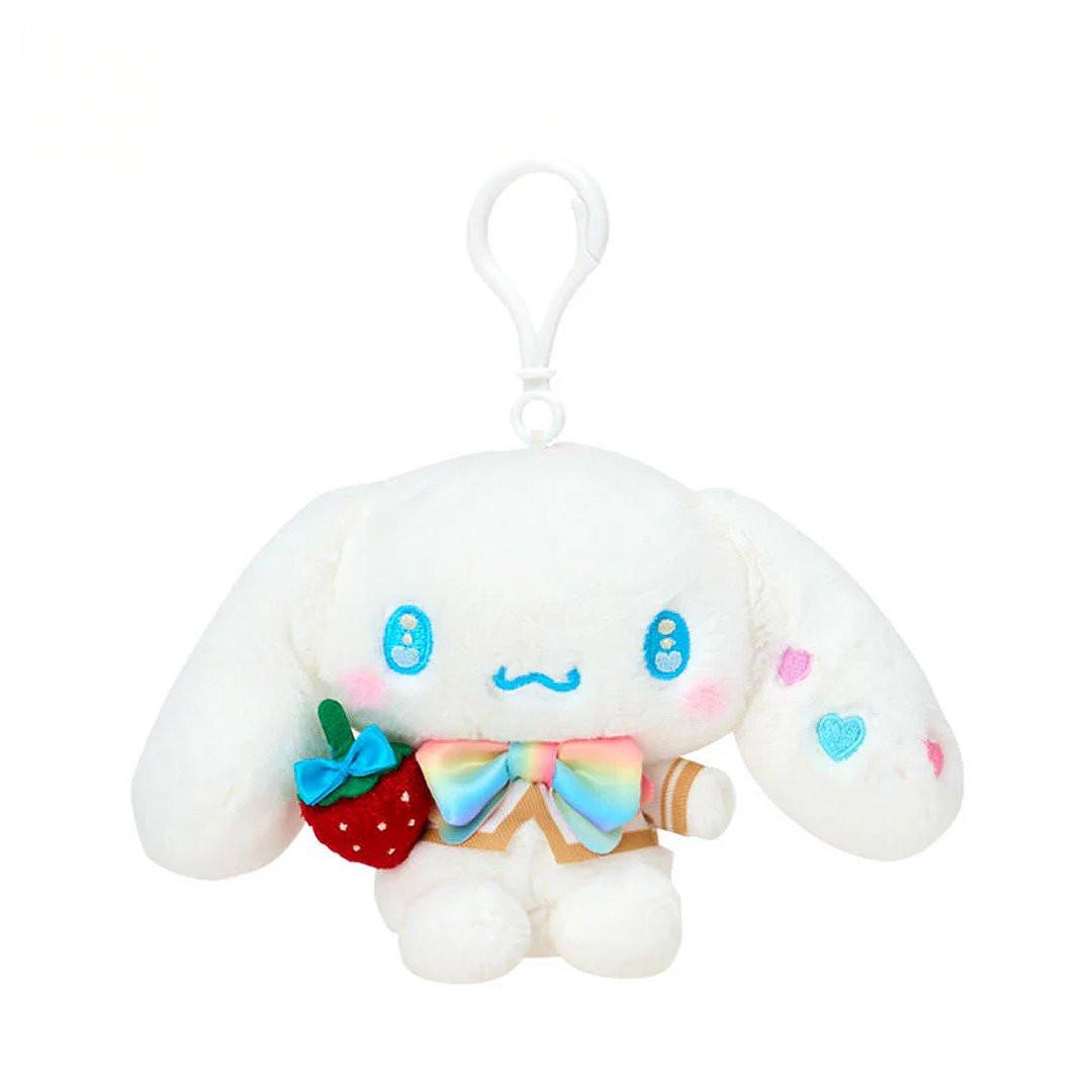 White Cinnamoroll plush keychain with a strawberry and rainbow bow on a white background