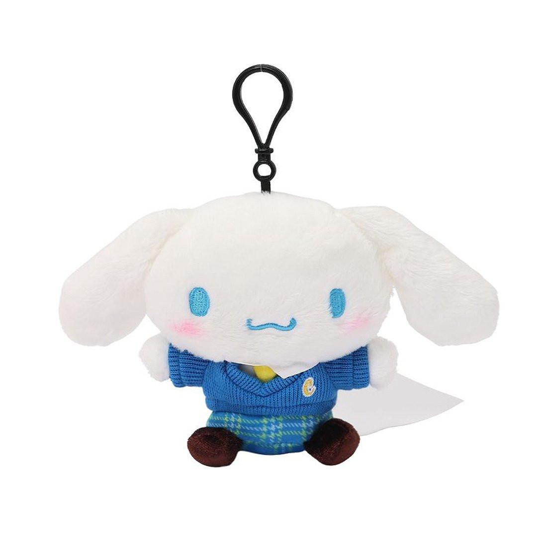 Officially licensed Cinnamoroll bag clip plush doll wearing a in a school uniform. He wears a blue plaid skirt, a V-neck blue sweater, a yellow tie. Perfect size to attach to your backpack, bag, purse, car, or pants. Ideal collectible toy for fans and Sanrio enthusiasts.