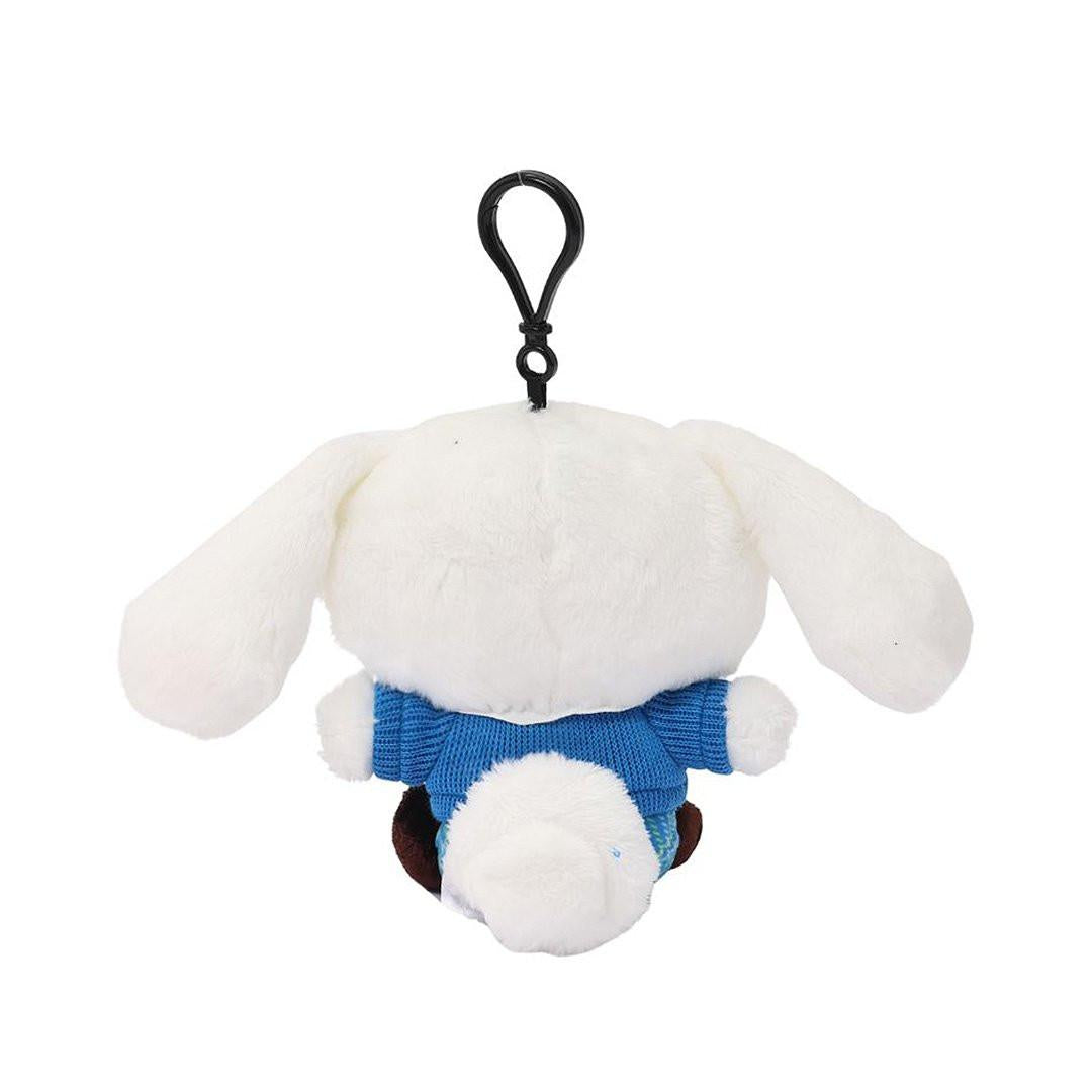 Officially licensed Cinnamoroll bag clip plush doll wearing a in a school uniform. He wears a blue plaid skirt, a V-neck blue sweater, a yellow tie. Perfect size to attach to your backpack, bag, purse, car, or pants. Ideal collectible toy for fans and Sanrio enthusiasts.