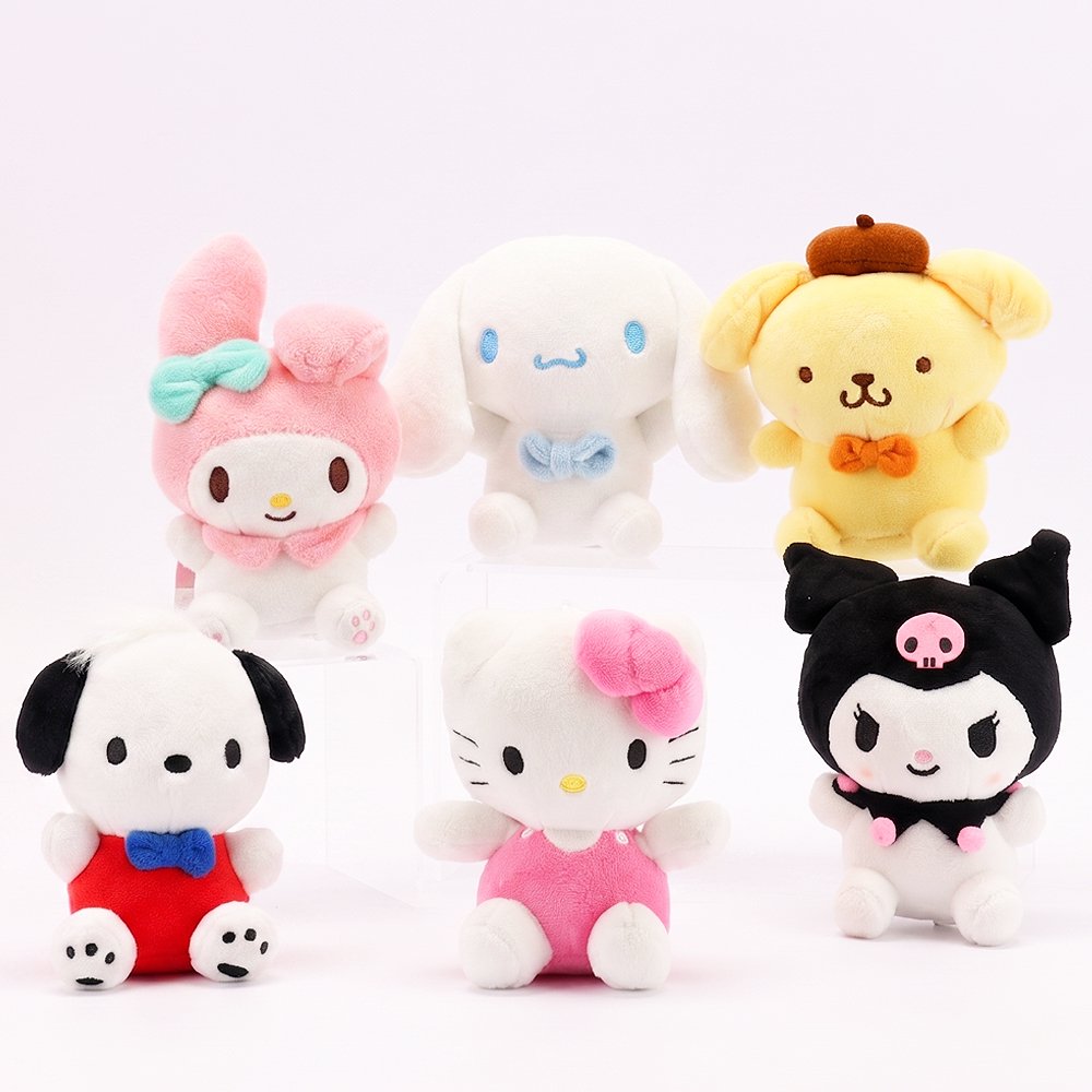 An officially licensed Class of 2026 Sanrio graduation gift set featuring six popular plush characters, Hello Kitty, My Melody, Cinnamoroll, Kuromi, Pompompurin, and Pochacco wearing black graduation caps. The characters are arranged like a bouquet with silver star balloons and "Congrats Grad" decorations.