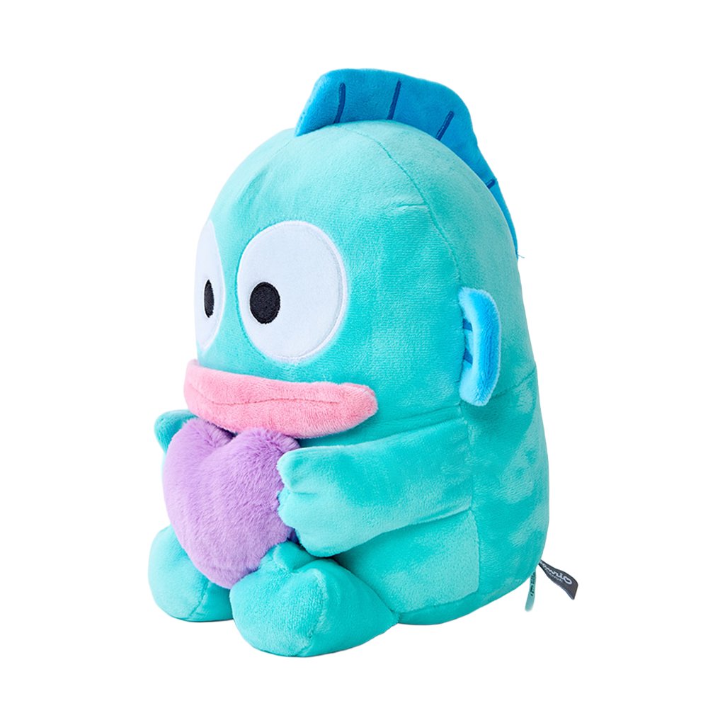 An officially licensed Hangyodon plush character in mint blue with pink lips, hugging a textured purple heart with both hands