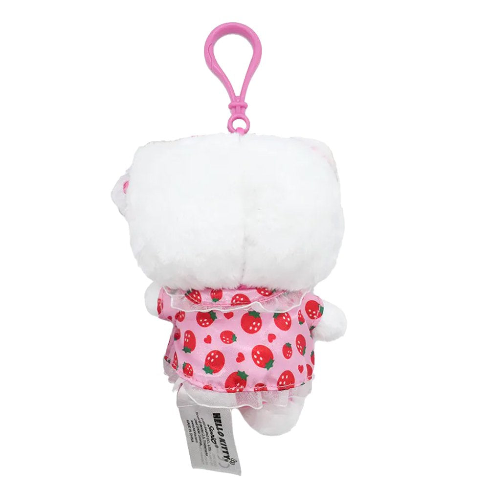 An officially licensed Hello Kitty plush keychain featuring Hello Kitty in a pink strawberry-patterned nightwear dress and a matching sleep mask, holding a small brown teddy bear.