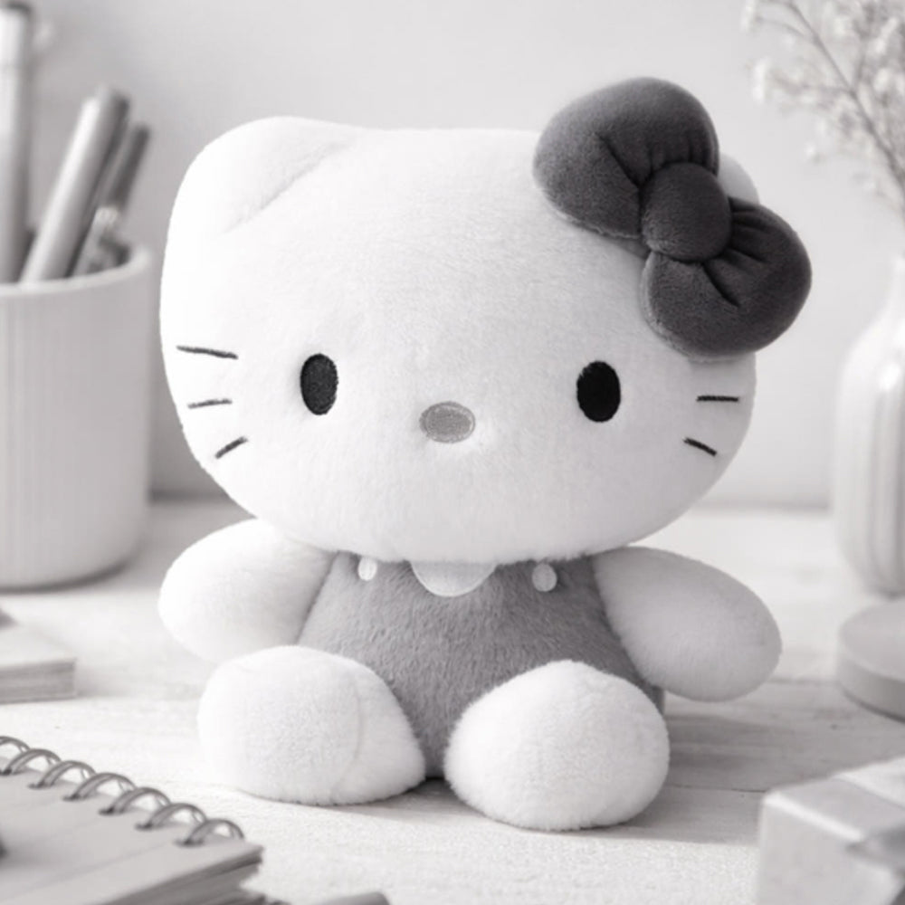 An officially licensed Sanrio Hello Kitty plush doll dressed in a grey outfit with a matching dark grey hair bow