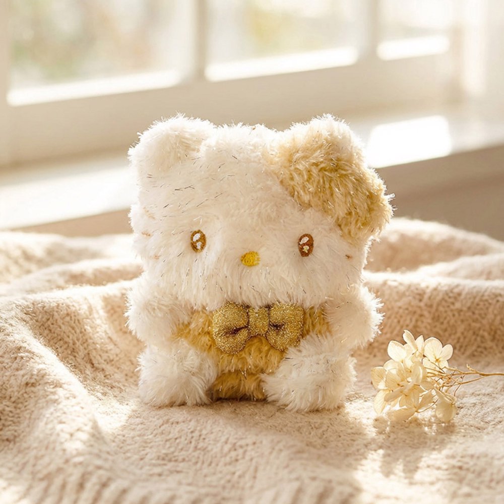 An officially licensed Sanrio small, fluffy Hello Kitty plush keychain with sparkling gold tinsel fur and a metallic gold bow.